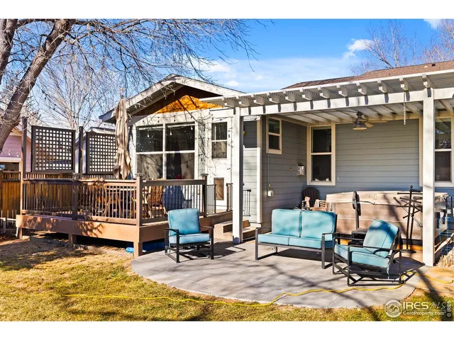 a view of a chairs and table in the back yard of the house