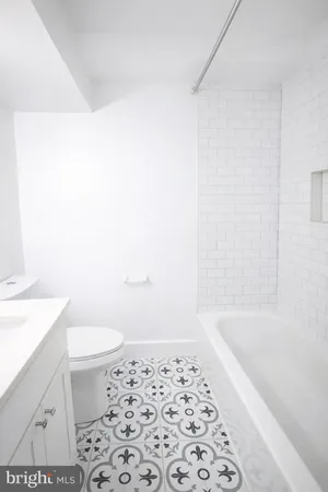 a bathroom with a bathtub and a toilet
