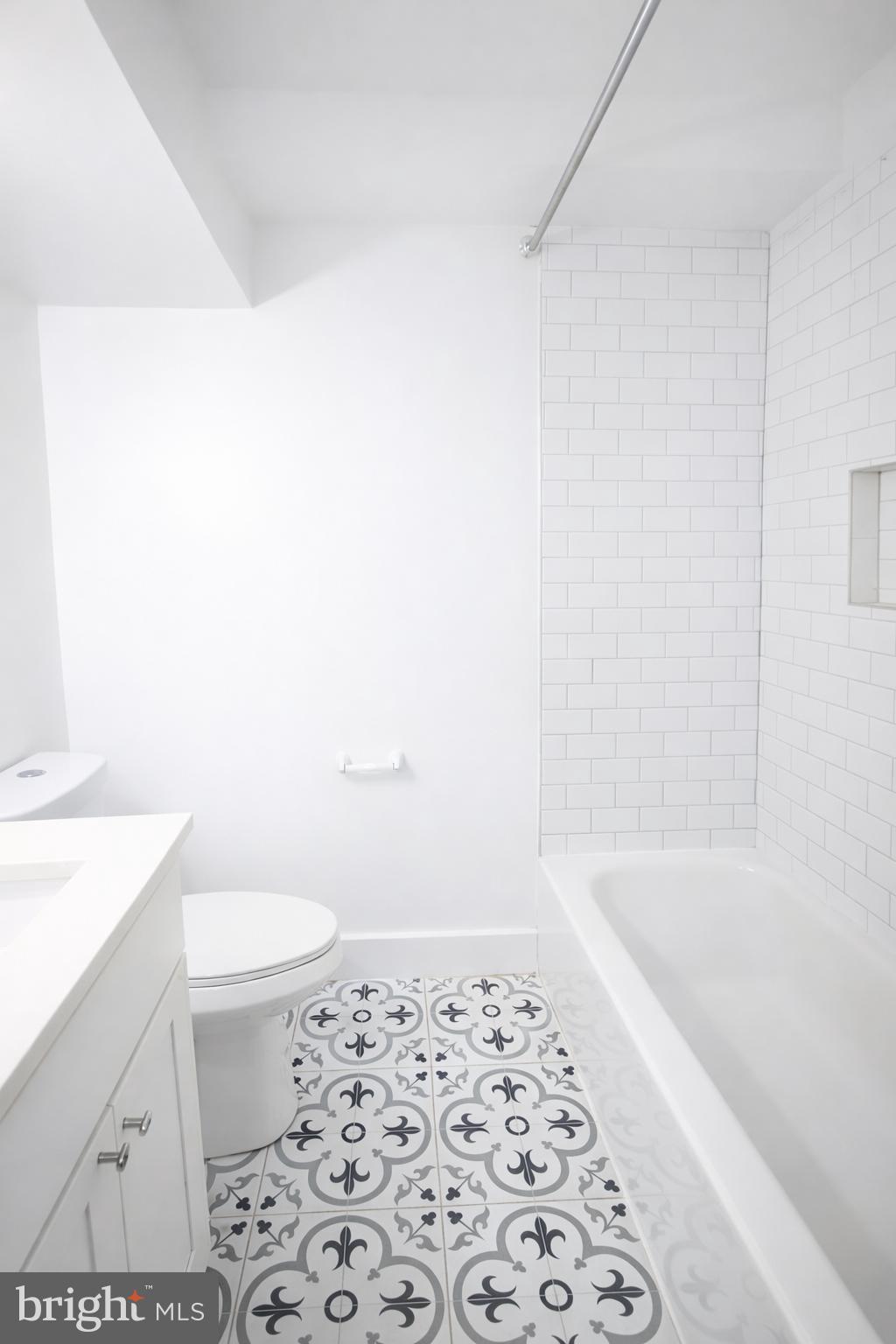 604 17th Street Northeast, Unit 1 2 Washington, DC 20002 - Photo 4 of 6 a bathroom with a bathtub and a toilet