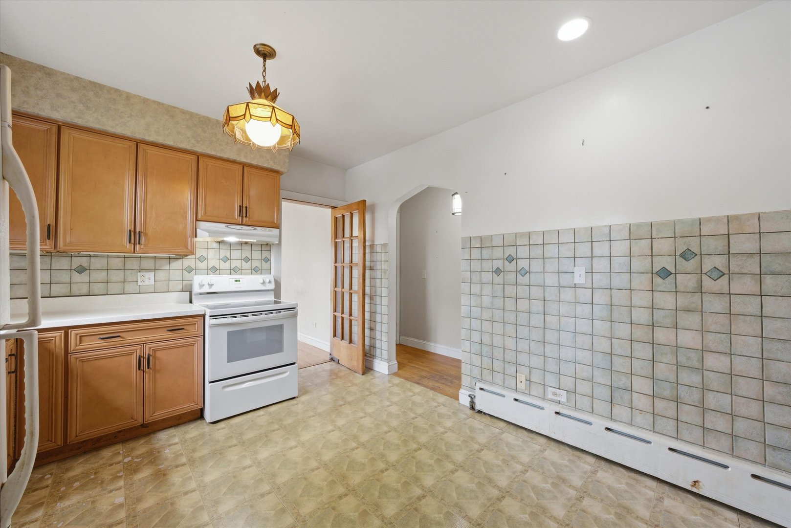 3100 Clinton Avenue Berwyn, IL 60402 - Photo 10 of 25 a kitchen with granite countertop a sink cabinets stainless steel appliances and a window