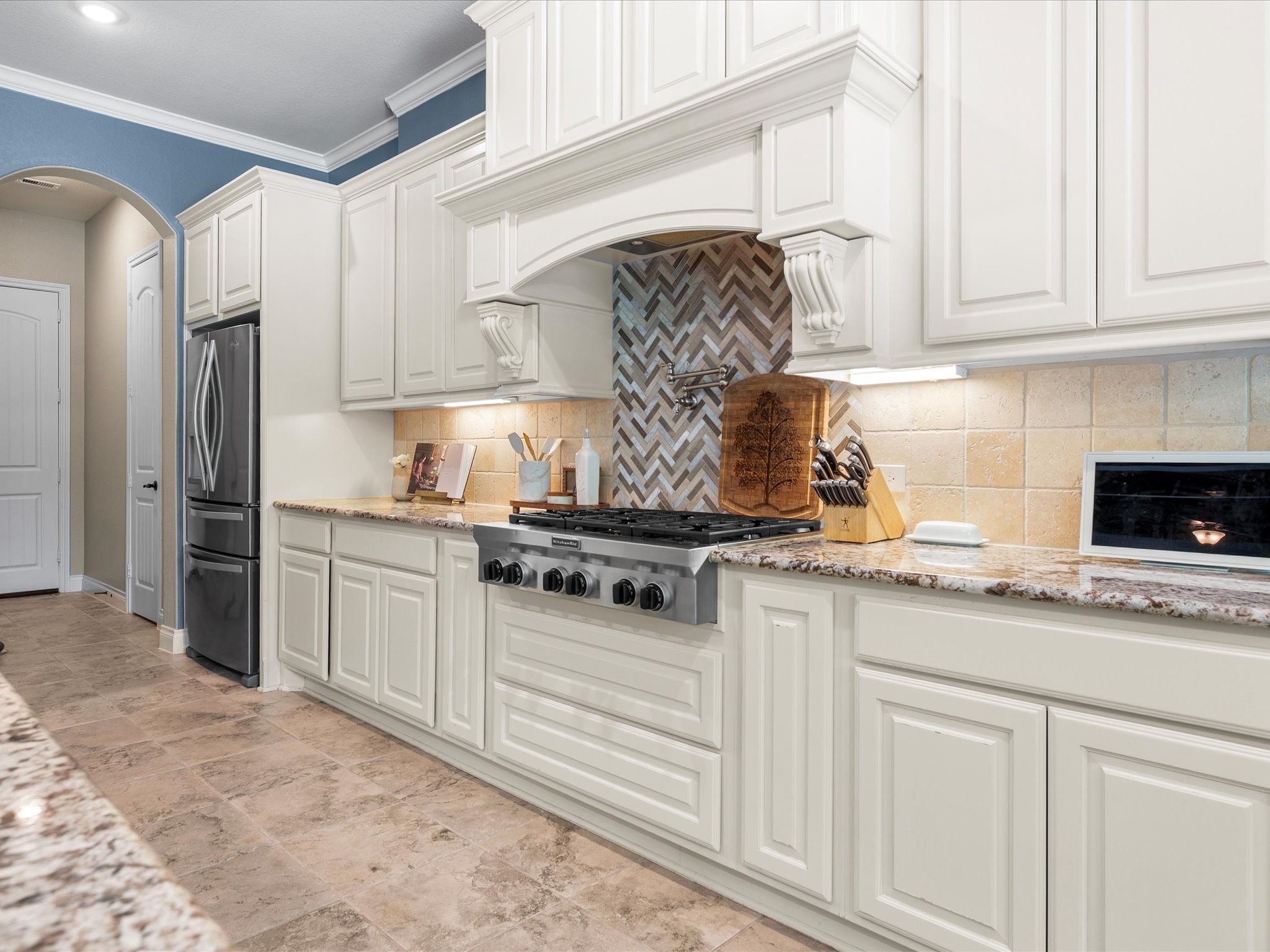 12618 Ranger Court Magnolia, TX 77354 - Photo 17 of 45 Instantly speed up cooking by skipping trips to the sink with pot filler hovering over the chefs gas range cook top. When folded back against the wall, it adds a polished, jewelry-like elegance to the backsplash.