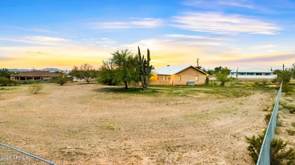 a view of a small house with backyard