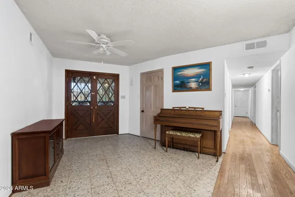 an empty room with furniture and natural light