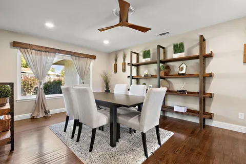 a view of a dining room with furniture window and wooden floor