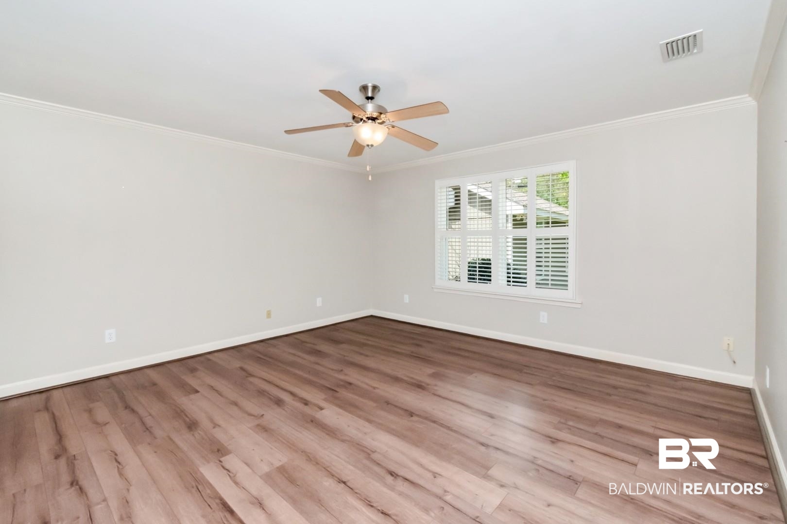 8 Lancaster Road Mobile, AL 36608 - Photo 12 of 24 Unfurnished room with ornamental molding, wood finished floors, and ceiling fan