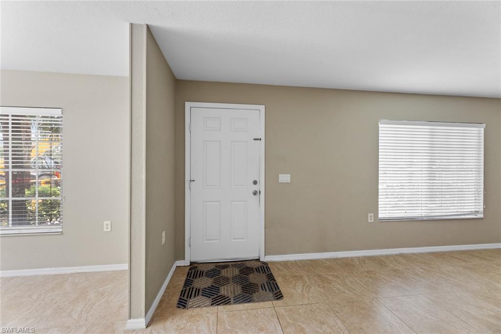 9450 Ivy Brook Run, Unit 602 Fort Myers, FL 33913 - Photo 1 of 34 an empty room with windows