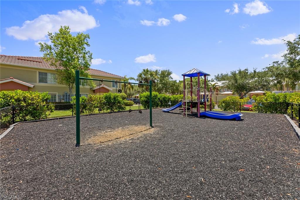 9450 Ivy Brook Run, Unit 602 Fort Myers, FL 33913 - Photo 25 of 34 a sign board with flower plants and wooden fence