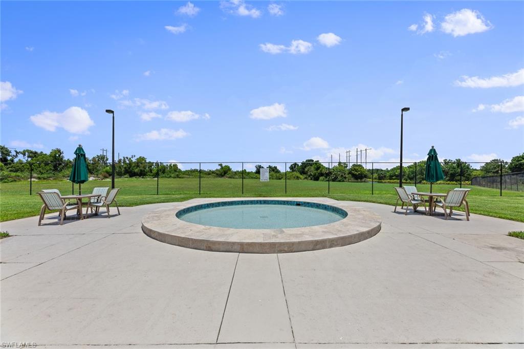 9450 Ivy Brook Run, Unit 602 Fort Myers, FL 33913 - Photo 30 of 34 a view of a swimming pool and a back yard