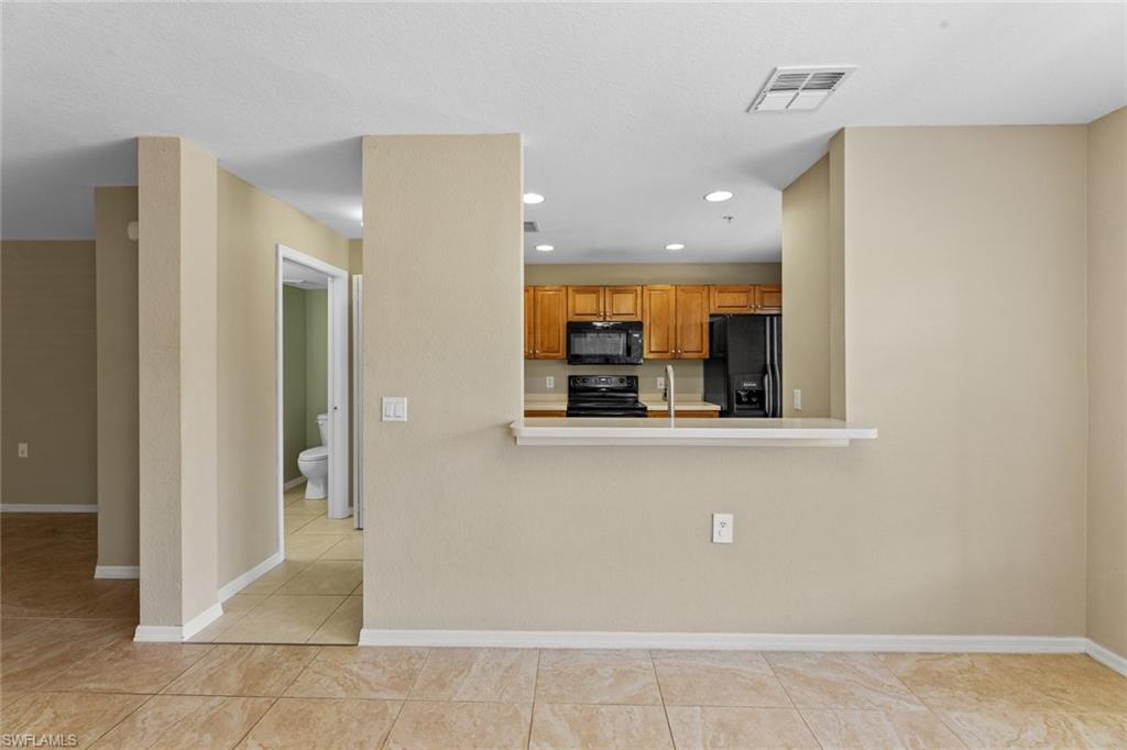 9450 Ivy Brook Run, Unit 602 Fort Myers, FL 33913 - Photo 8 of 34 a view of kitchen with refrigerator and window