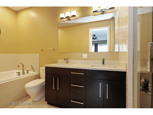 2144 West Rice Street, Unit 1W Chicago, IL 60622 - Photo 8 of 22 a bathroom with a sink mirror and toilet