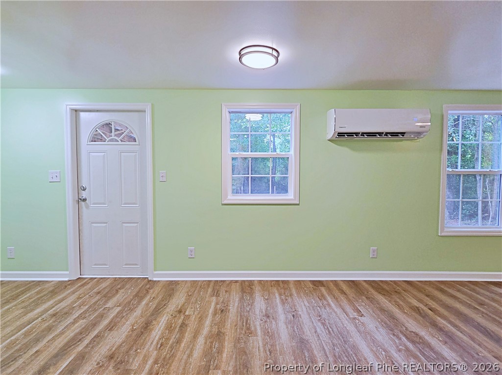 1031 Pine Acres Road White Oak, NC 28399 - Photo 7 of 29 a view of a room with wooden floor and windows