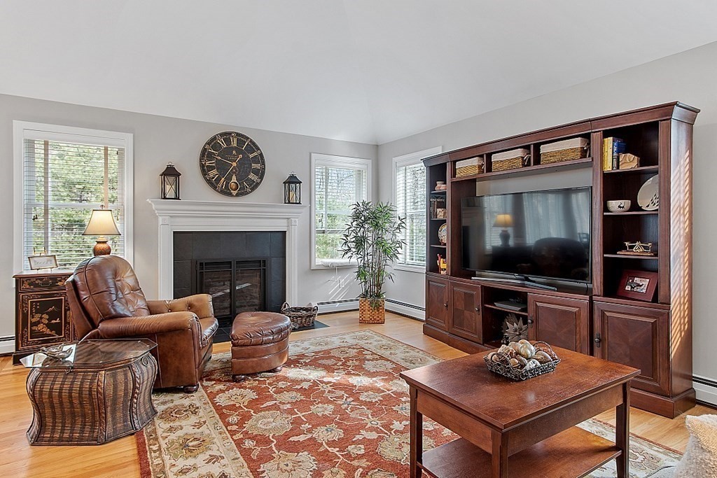9 Joco Drive Tyngsborough, MA 01879 - Photo 16 of 38 a living room with furniture a flat screen tv and a fireplace