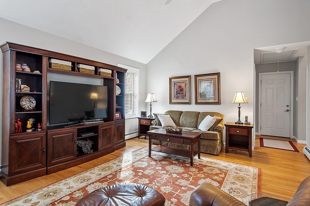 9 Joco Drive Tyngsborough, MA 01879 - Photo 17 of 38 a living room with furniture and a flat screen tv