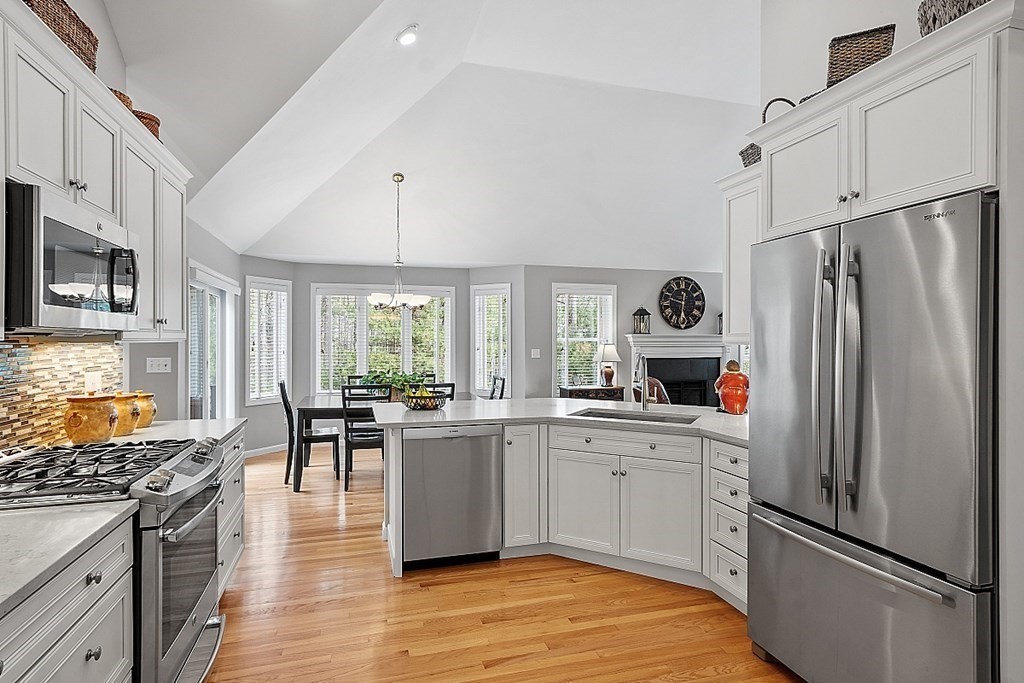 9 Joco Drive Tyngsborough, MA 01879 - Photo 10 of 38 a kitchen with stainless steel appliances a refrigerator stove and sink