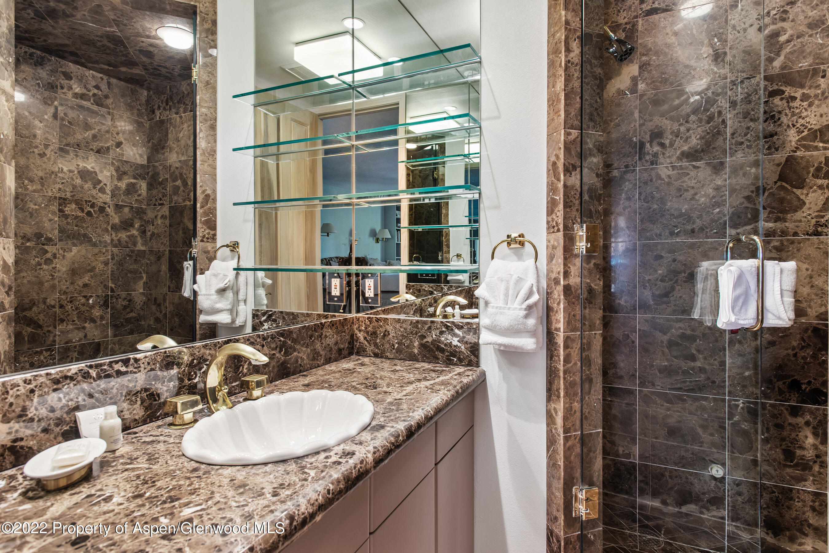 237 Gilbert Street Aspen, CO 81611 - Photo 11 of 28 a bathroom with a granite countertop sink a mirror and shower