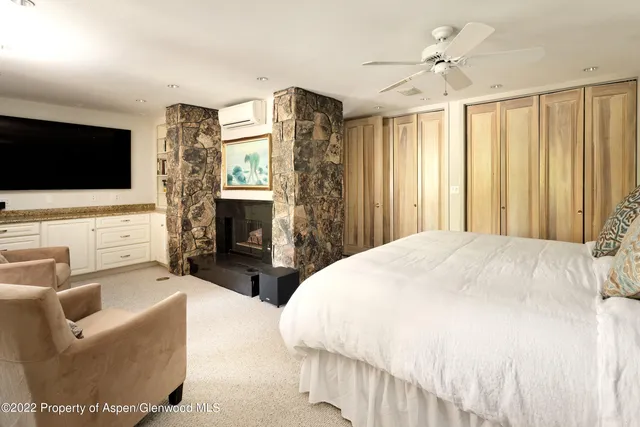 a bedroom with bed and a large window