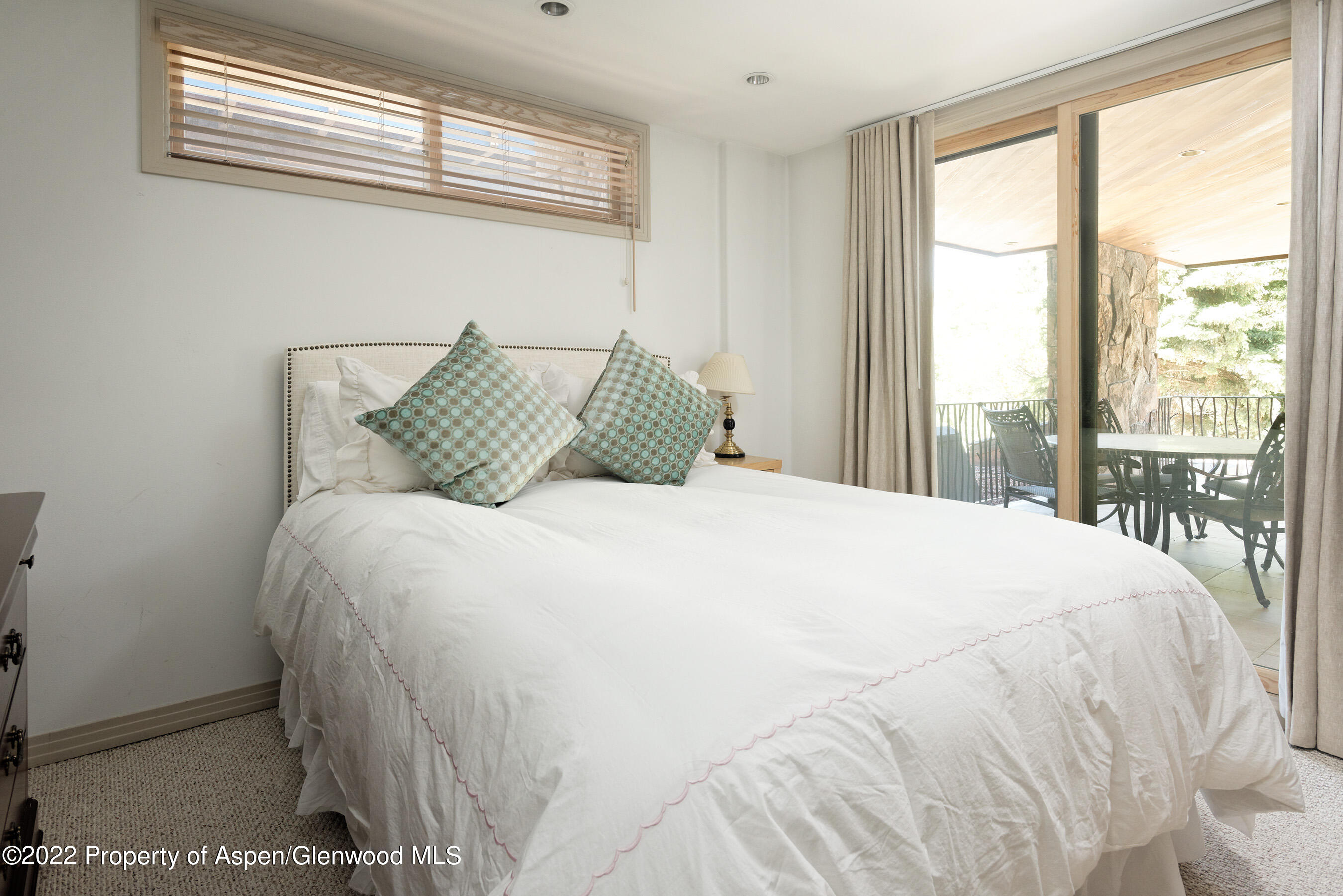 237 Gilbert Street Aspen, CO 81611 - Photo 14 of 28 a large bed sitting in a bedroom next to a window