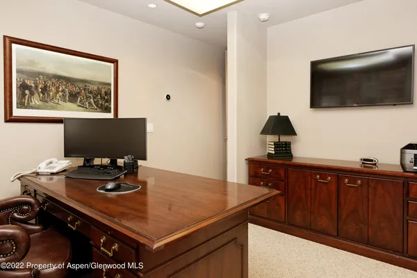 a utility room with granite countertop a sink a washer and dryer with wooden cabinets