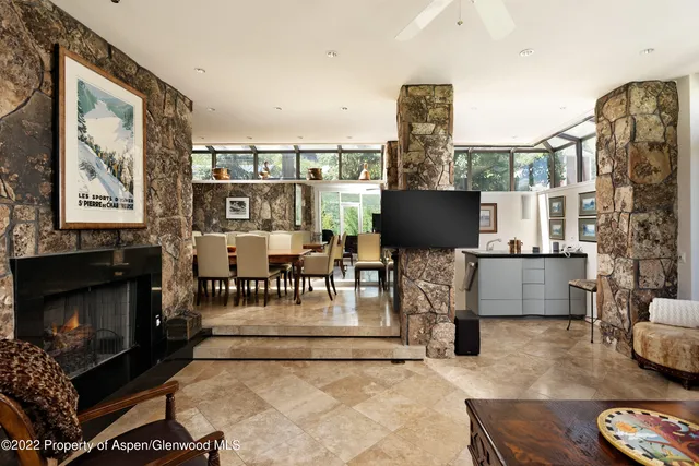 a living room with furniture a flat screen tv and a fireplace