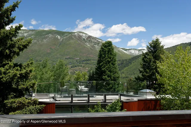 a view of a city with lush green forest
