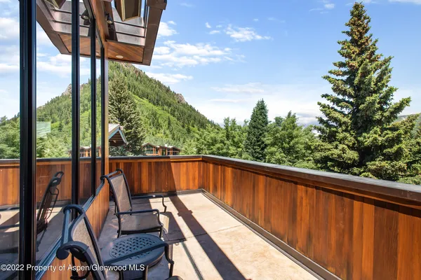a view of a balcony with chairs