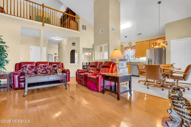 a living room with fireplace furniture and a large window