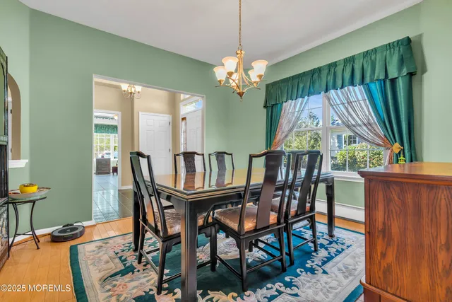 a view of a dining room with furniture and a chandelier