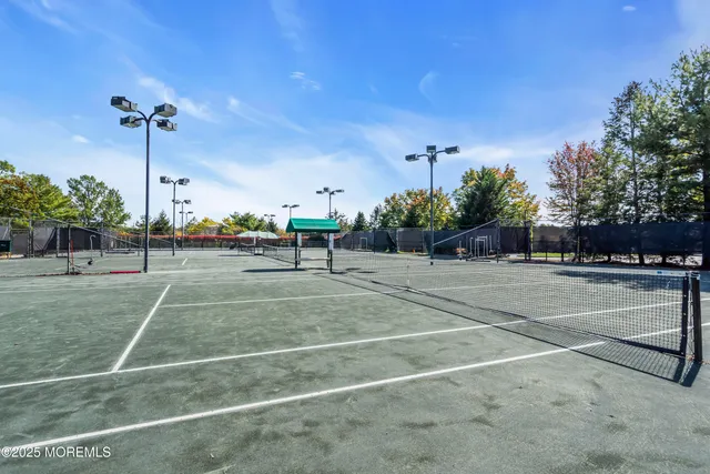 a swimming pool with lots of trees in the background