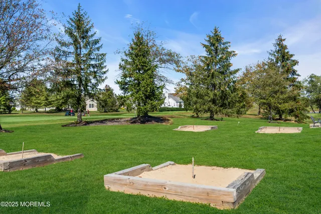 a view of a house with a yard and a pond