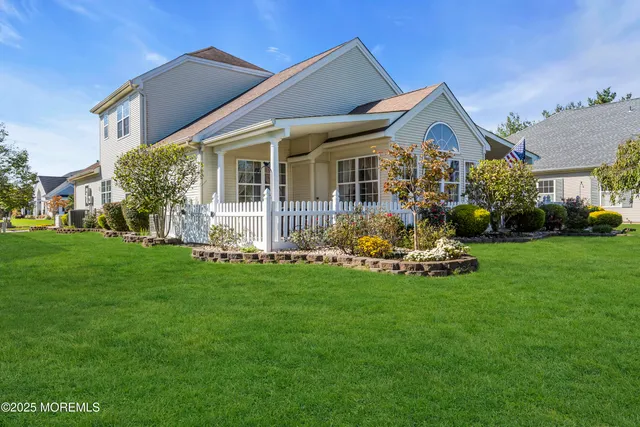 a front view of a house with a garden and yard