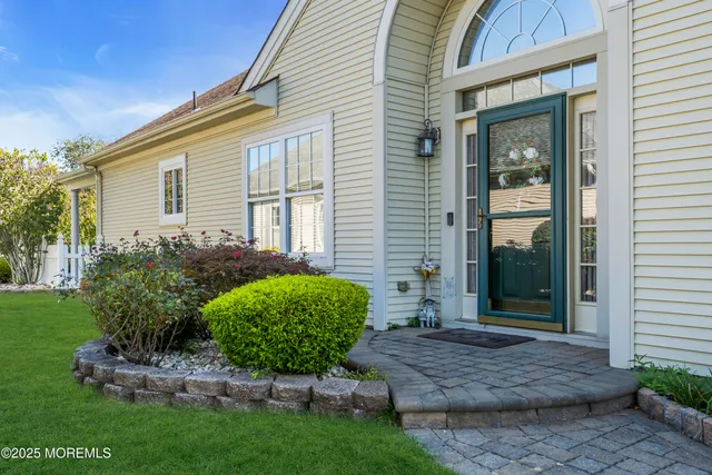 a view of a backyard with plants and outdoor seating