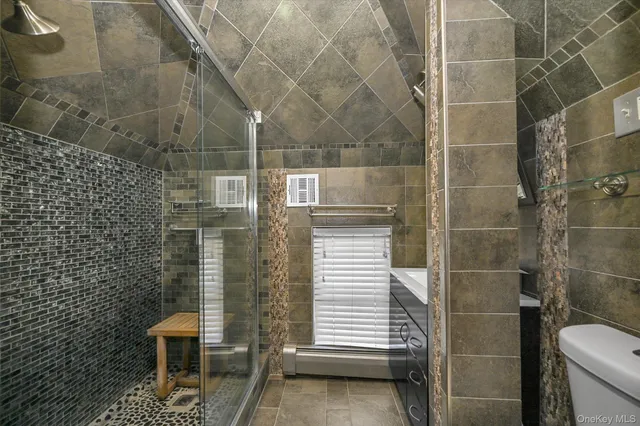 a bathroom with a toilet and a shower