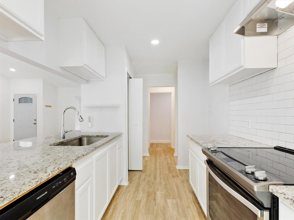 6702 Umphress Road Dallas, TX 75217 - Photo 11 of 22 a kitchen with granite countertop a sink stove and refrigerator