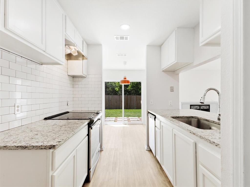 6702 Umphress Road Dallas, TX 75217 - Photo 12 of 22 a kitchen with granite countertop a sink and cabinets