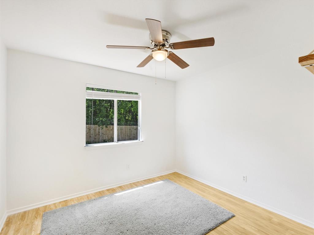 6702 Umphress Road Dallas, TX 75217 - Photo 15 of 22 an empty room with a window and a ceiling fan