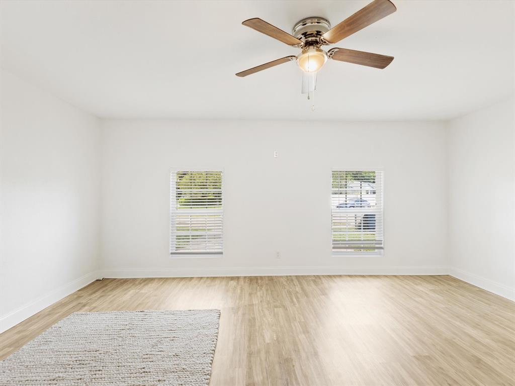 6702 Umphress Road Dallas, TX 75217 - Photo 4 of 22 an empty room with a window and ceiling fan