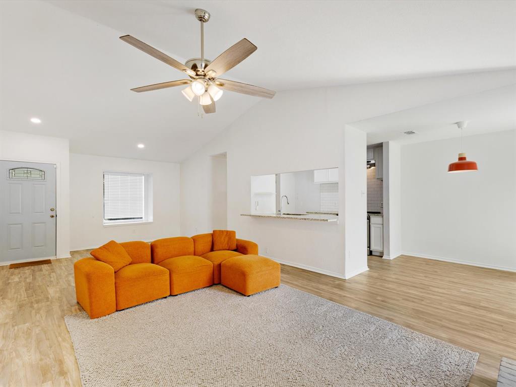6702 Umphress Road Dallas, TX 75217 - Photo 5 of 22 a living room with furniture kitchen view and a chandelier
