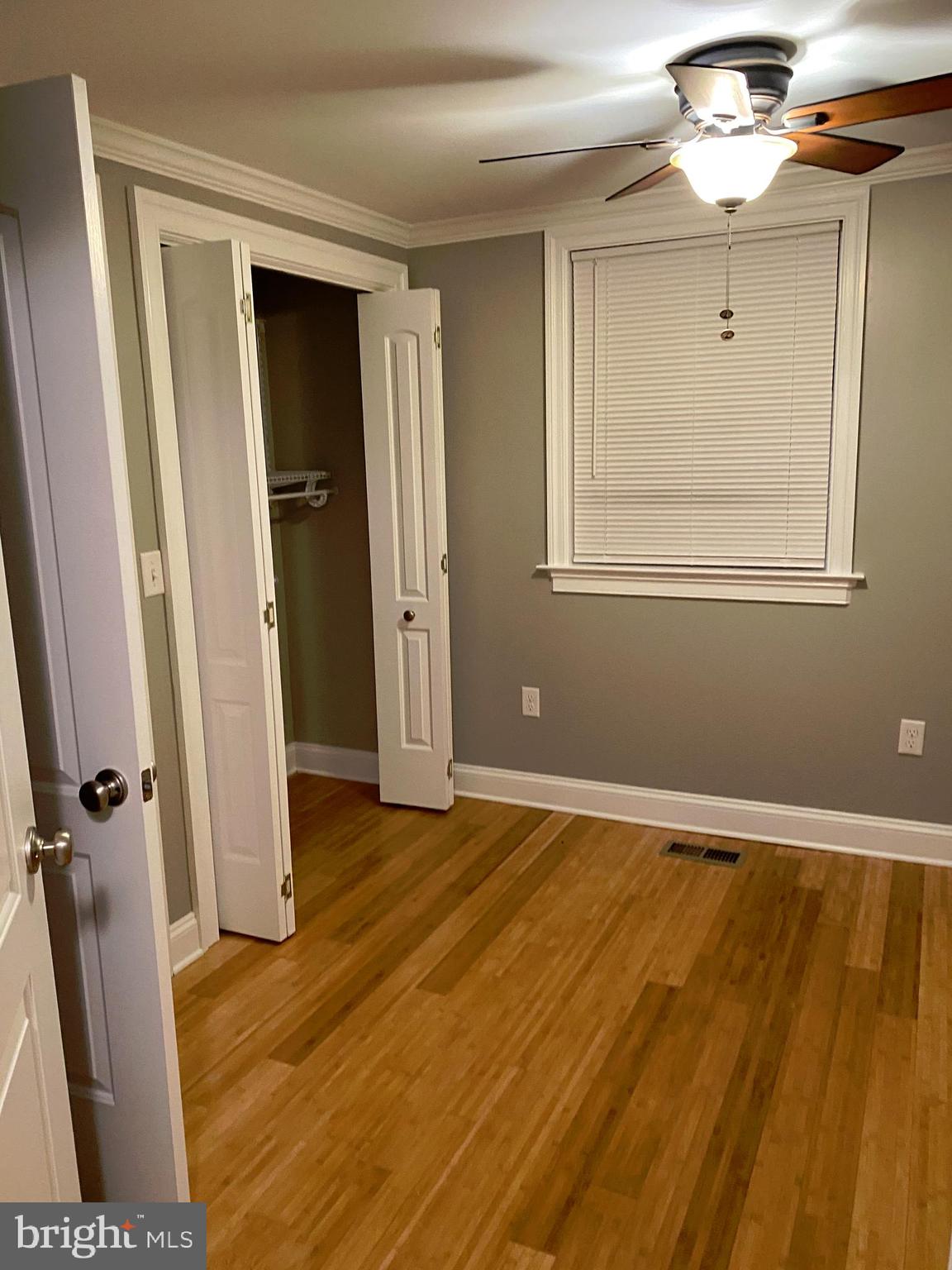 7109 Daffodil Lane Newark, MD 21841 - Photo 13 of 21 wooden floor in an empty room with a window