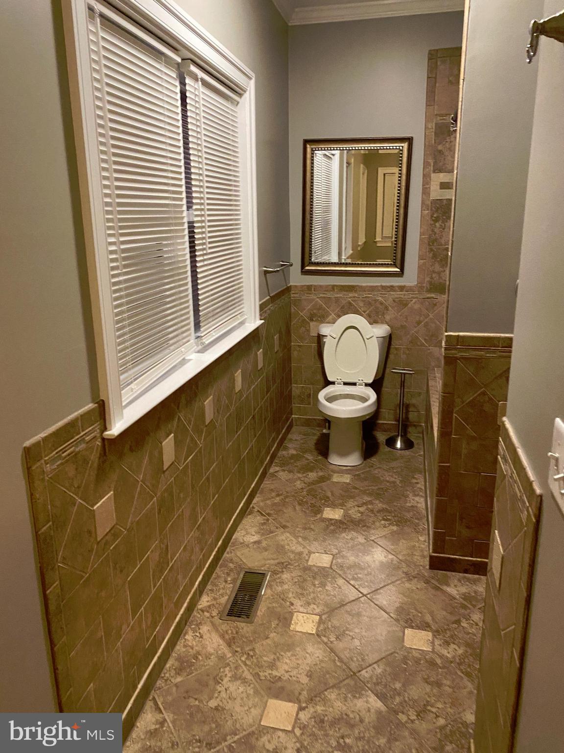 7109 Daffodil Lane Newark, MD 21841 - Photo 15 of 21 a bathroom with a toilet and a window