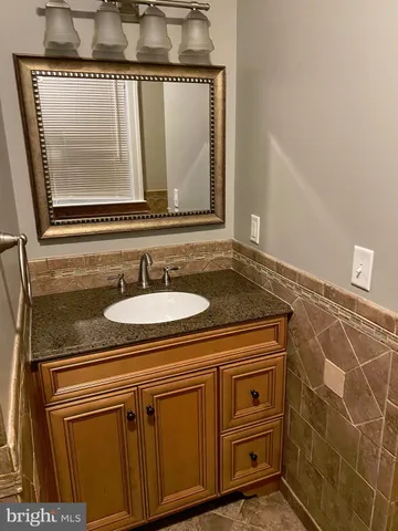 a bathroom with a sink a vanity and a mirror
