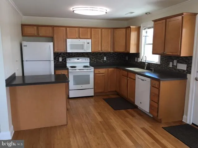 a kitchen with wooden cabinets and a sink