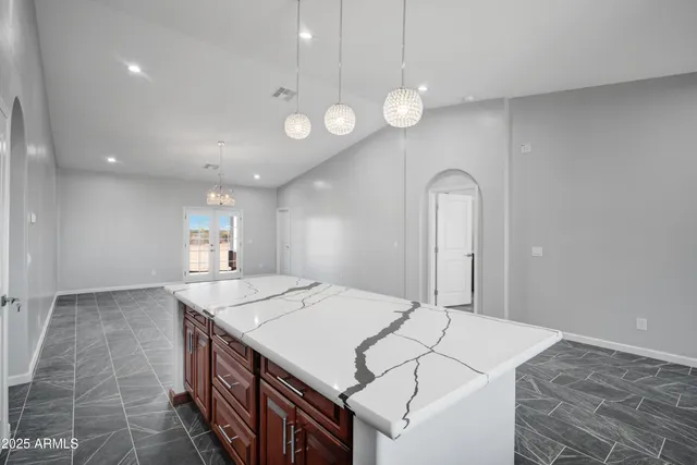 a kitchen that has a microwave a sink and a stove in it