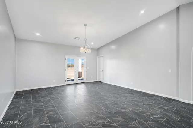 an empty room with wooden floor and door
