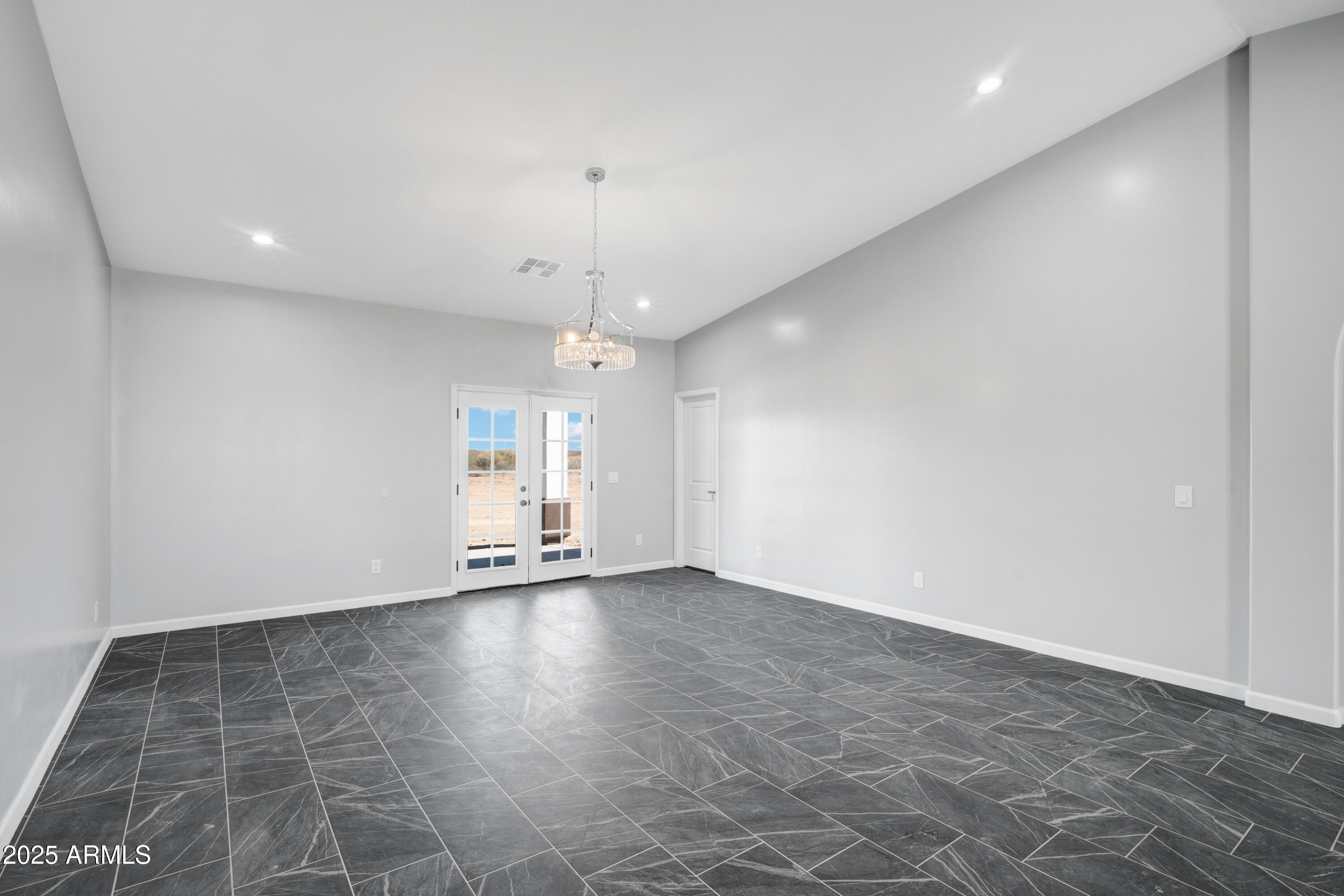 35532 West Chipman Road Tonopah, AZ 85354 - Photo 12 of 30 an empty room with wooden floor and door