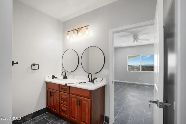 a bathroom with a double vanity sink mirror and a shower
