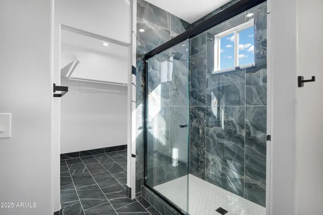 a bathroom with a shower and a sink