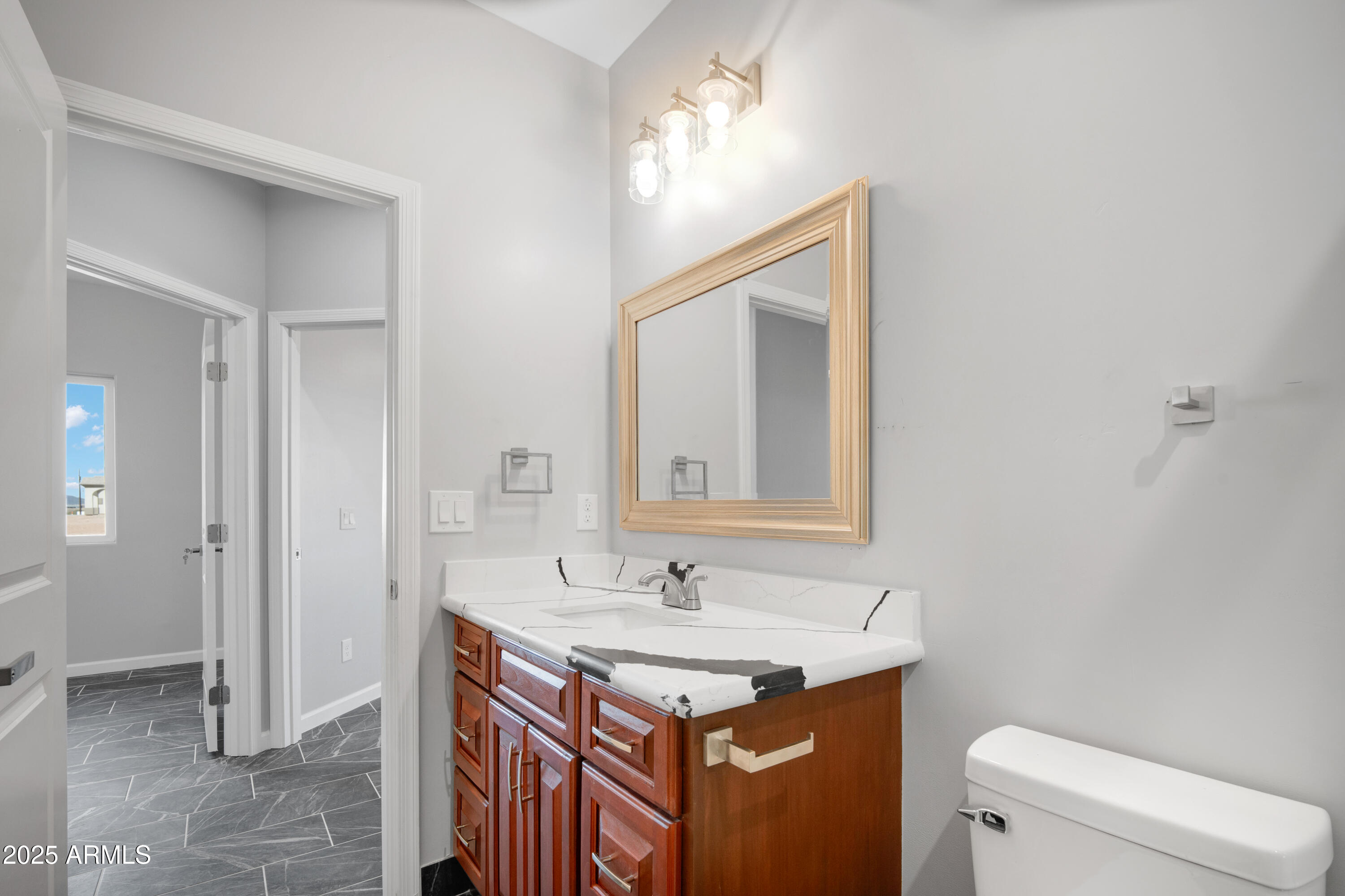 35532 West Chipman Road Tonopah, AZ 85354 - Photo 21 of 30 a bathroom with a sink a toilet and a mirror