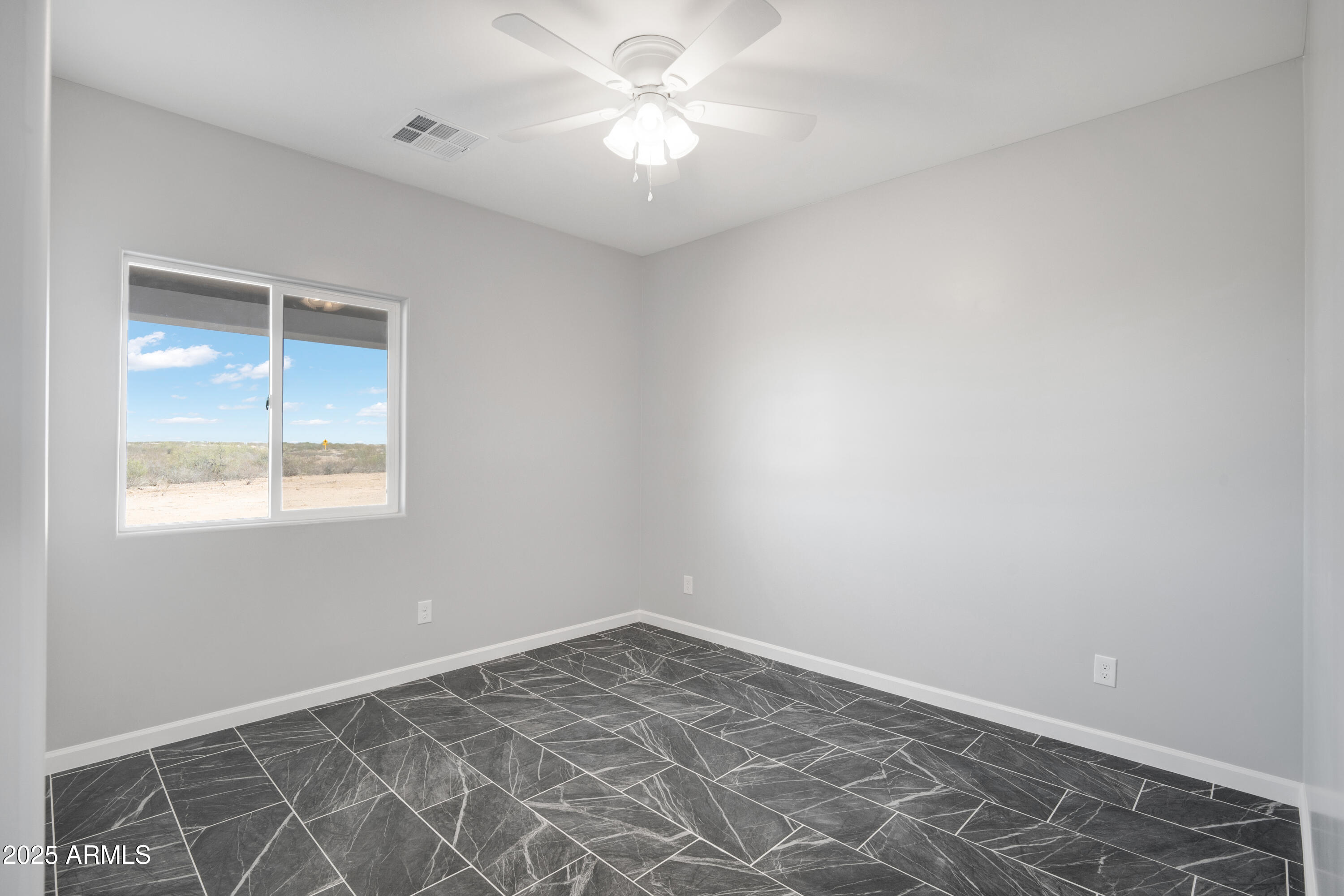 35532 West Chipman Road Tonopah, AZ 85354 - Photo 24 of 30 an empty room with a fan and a window