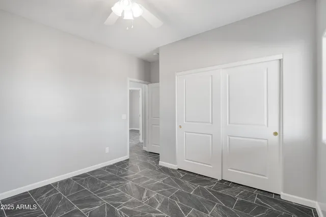 an empty room with a ceiling fan