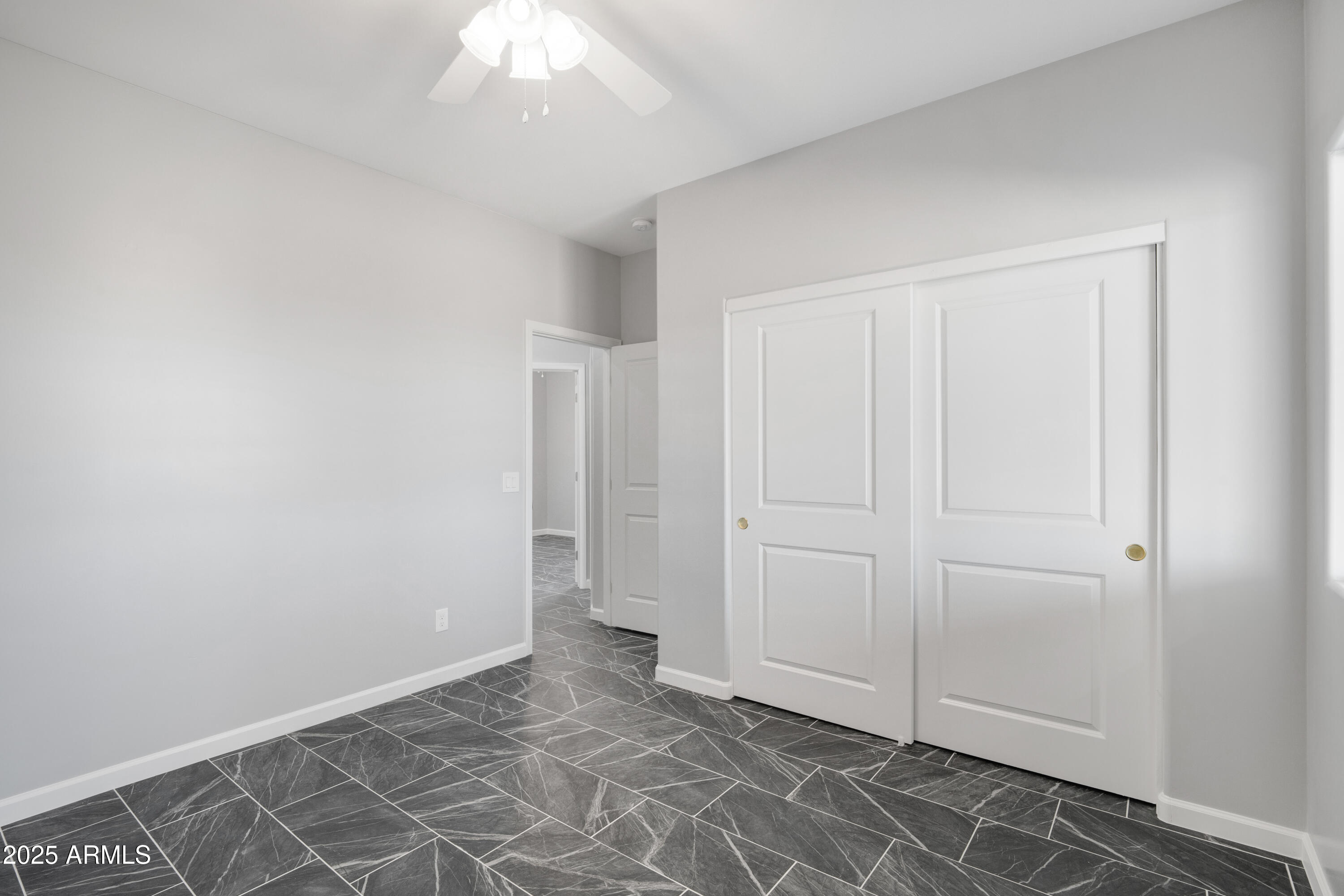 35532 West Chipman Road Tonopah, AZ 85354 - Photo 25 of 30 an empty room with a ceiling fan